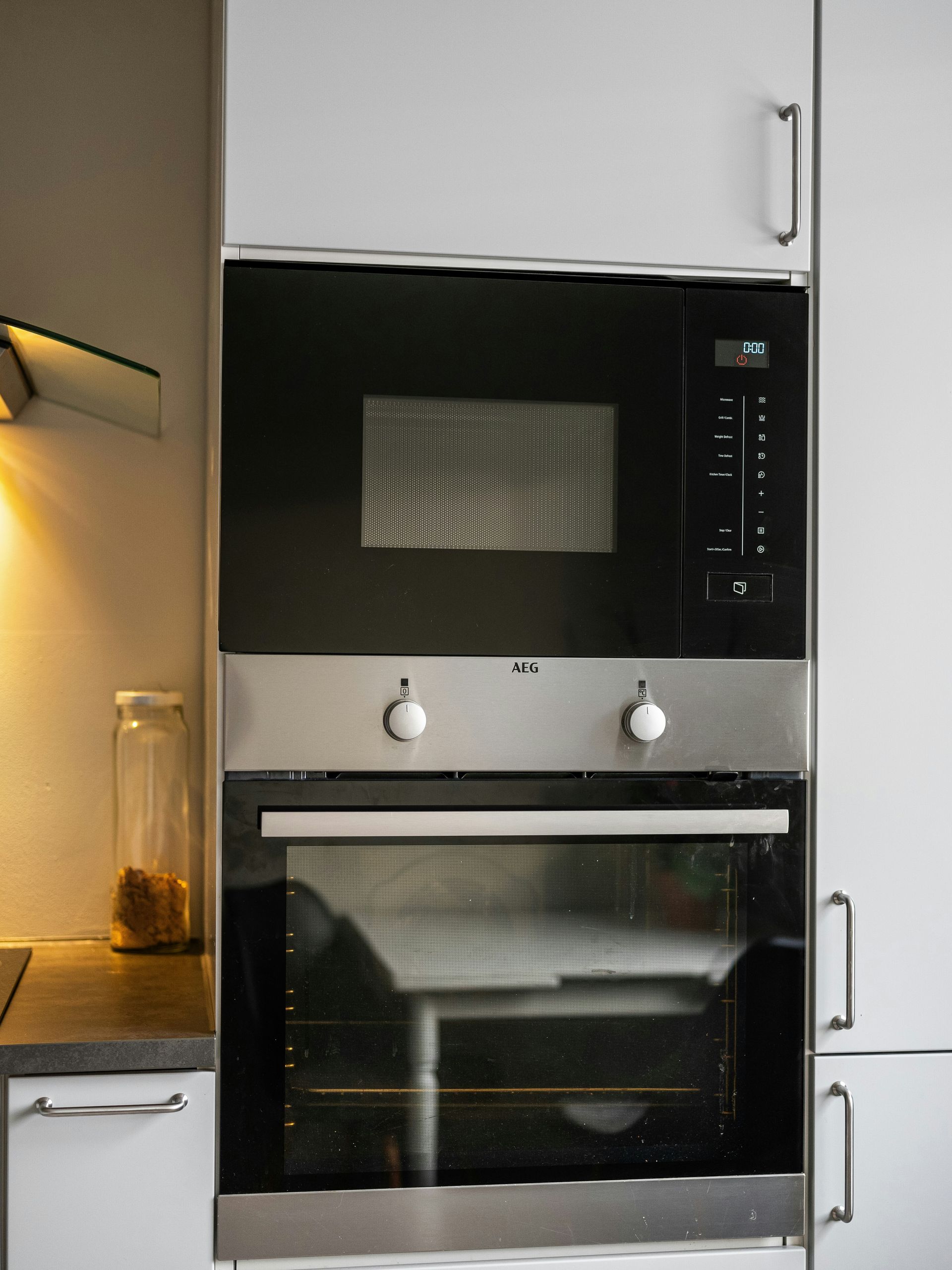 A black and silver oven and microwave in a kitchen